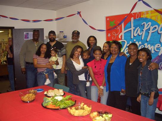 A joyful family gathering takes place with plenty of food and smiling faces in a decorated space.