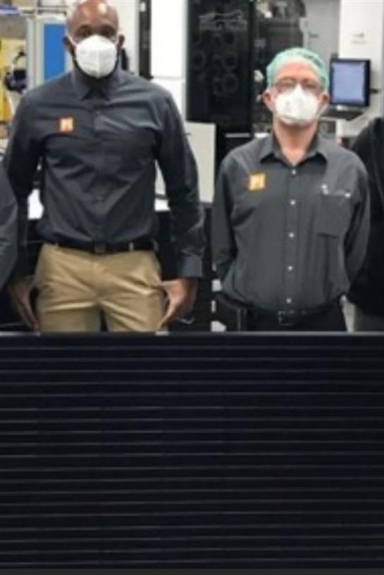 A man in a mask and a man in a black shirt