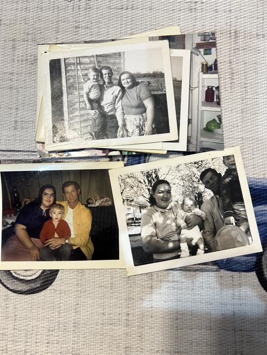 Several black and white family photographs display cherished memories of togetherness and happiness.