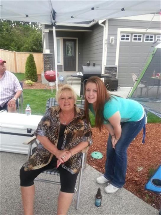Enjoying a lively family gathering in the backyard under a tent during a sunny afternoon.