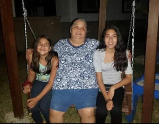 A group of people sitting on a swing