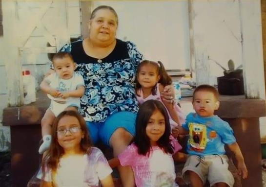 A woman sitting with several children