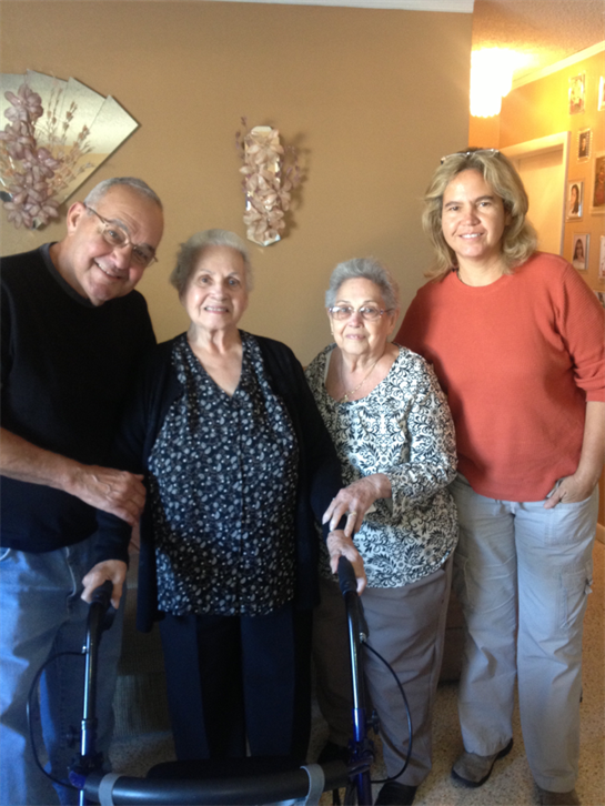 Four family members enjoying a joyful moment together inside a cozy residence.