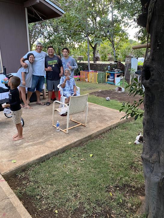 Family members enjoy a sunny afternoon together in a backyard, filled with laughter and bonding.