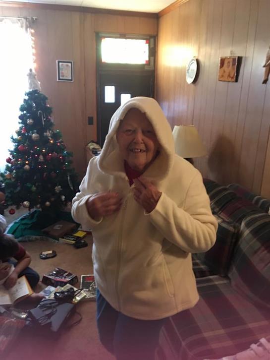 A woman wearing a white jacket with a hood