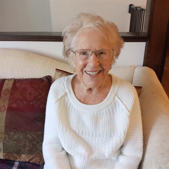 An old woman sitting on a couch