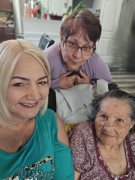 Three women enjoy a joyful time together in a warm and inviting home atmosphere.