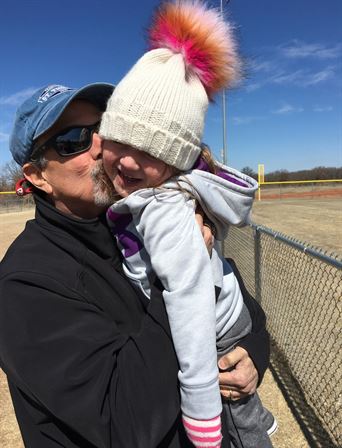 A man kissing a child