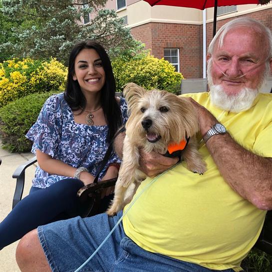 A man sitting on a bench with a dog