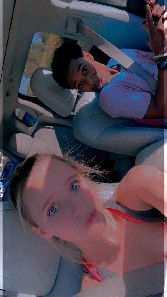 A selfie of a man and a woman in a car