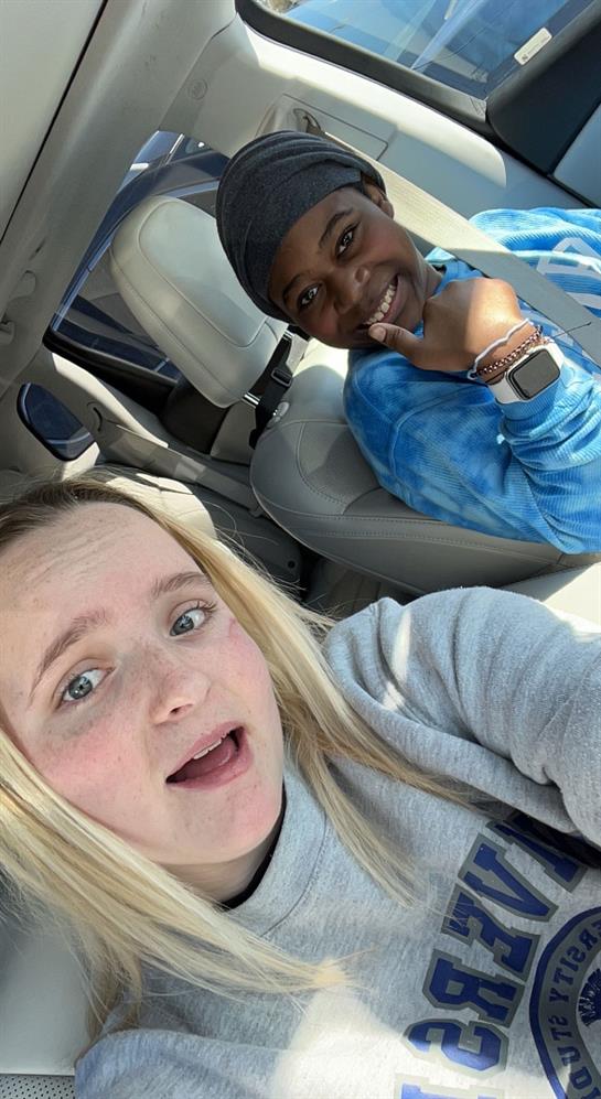 A selfie of a woman and a boy in a car