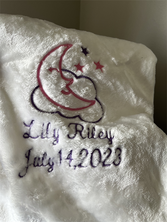 A white blanket with a moon and stars