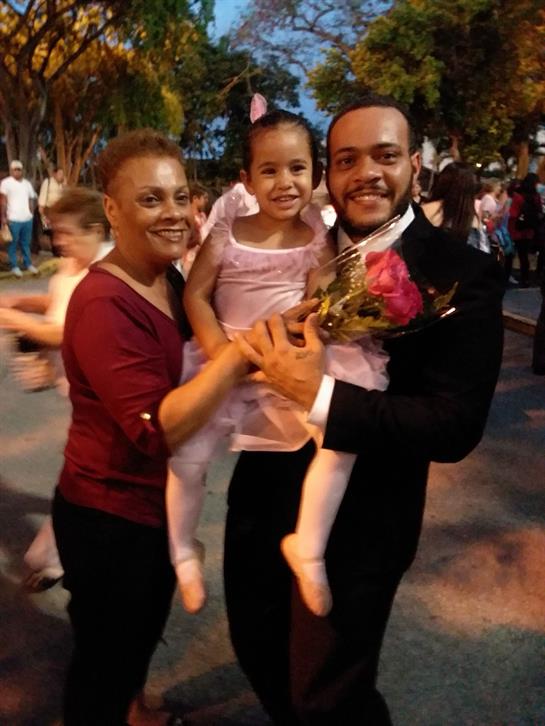 A joyful family celebrates together during an evening event, embracing happiness and connection.