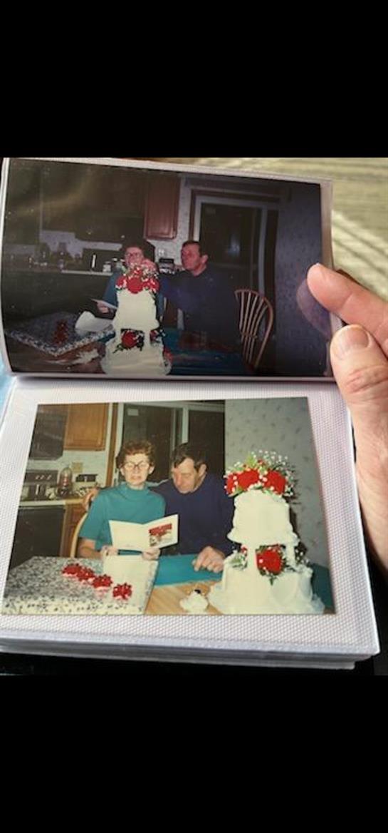 A hand holding a photo album