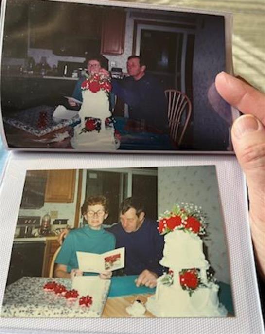 A hand holding a photo album