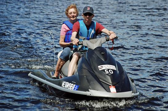 A man and woman on a jet ski