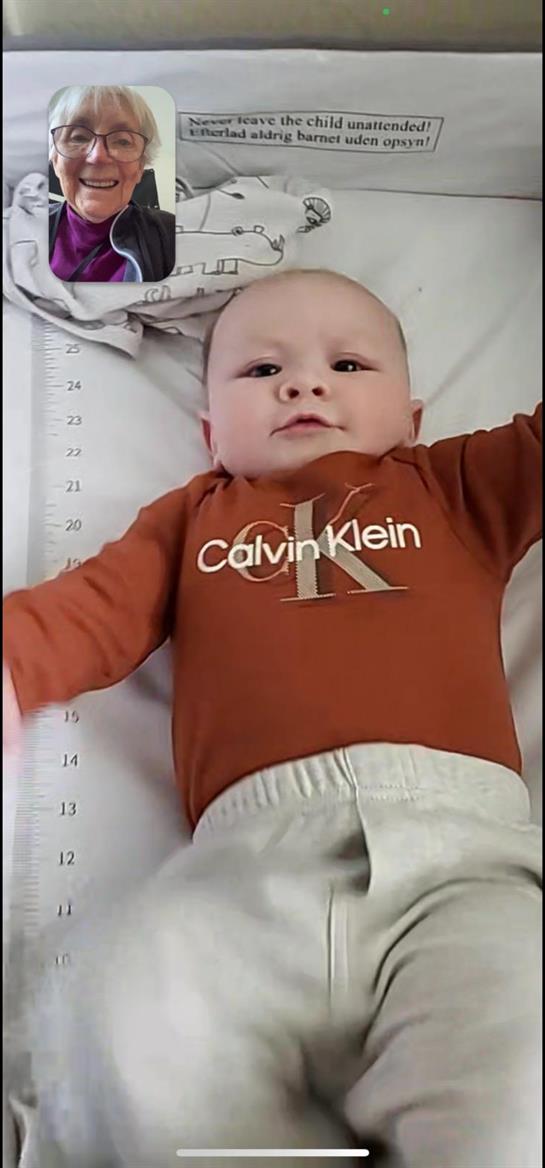A baby lying on a ruler