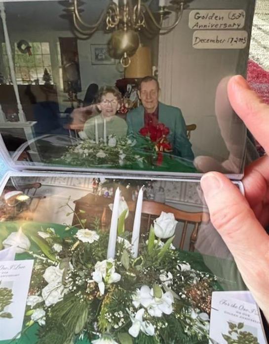 A hand holding a photo album