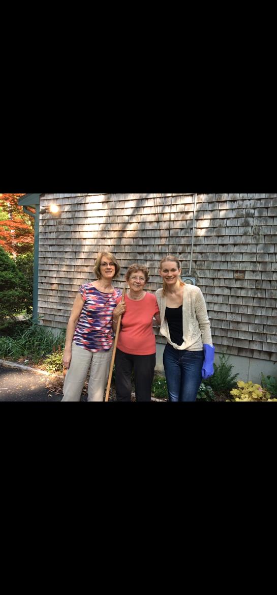 A group of women standing outside a house
