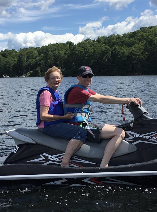 A man and woman on a jet ski