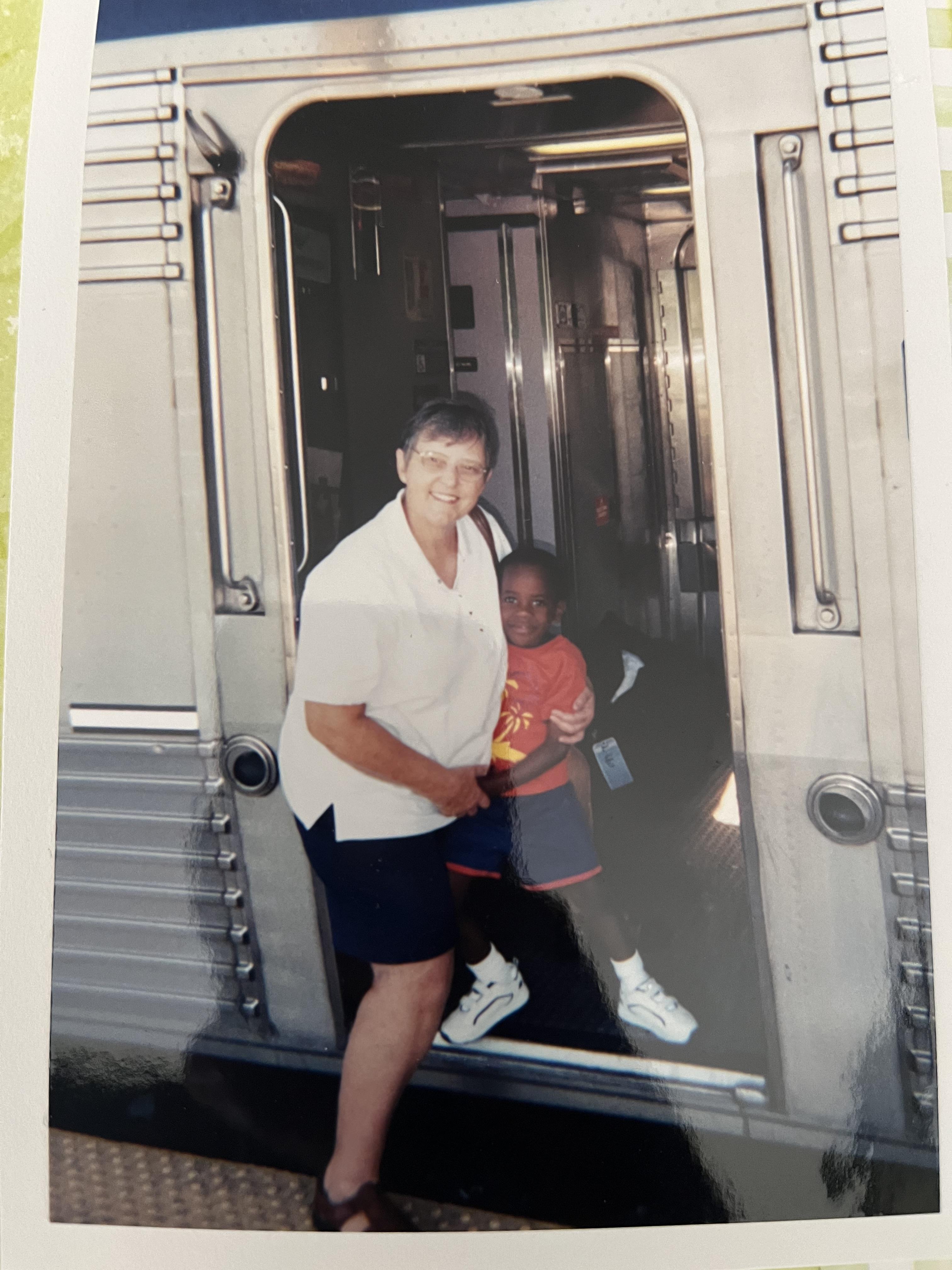 A woman and child standing in a train