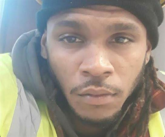 A construction worker takes a close-up selfie, highlighting his safety gear and focus.