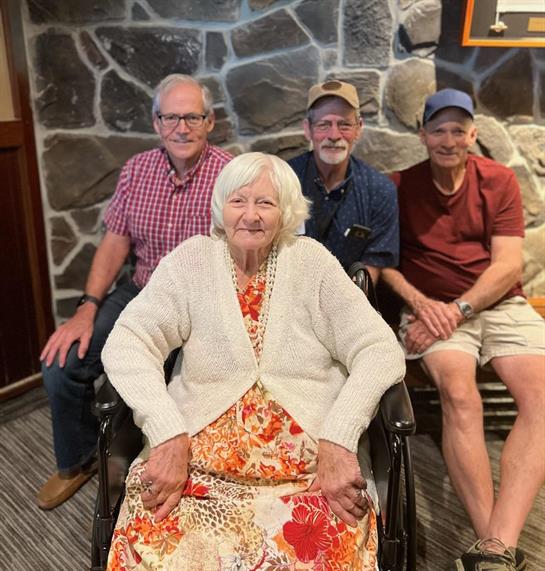 A group of people sitting in a wheelchair