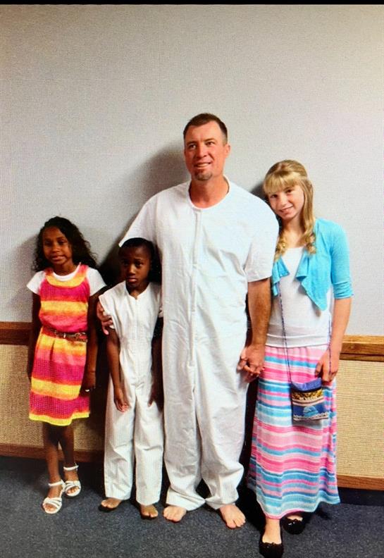 A man and two children posing for a picture
