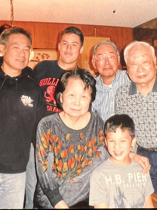 A joyful family gathers together, showcasing love across different generations in a warm space.