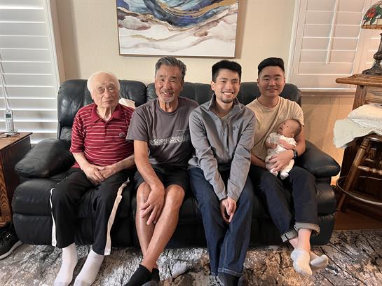 Four family members, spanning generations, enjoy quality time together in a welcoming setting.