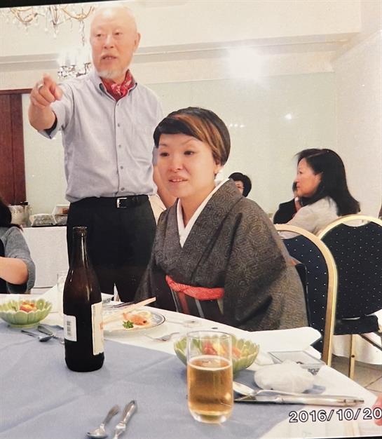 Guests enjoy a meal together while dressed in traditional clothing at a banquet.