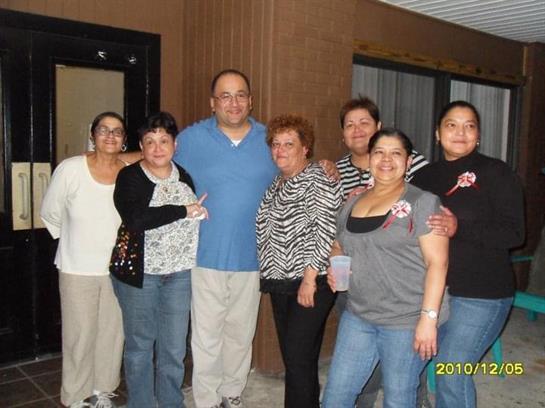 A lively gathering of friends enjoying a celebration at a venue, smiling and posing together.