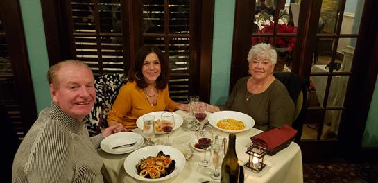 A group of women sitting at a table with plates of food