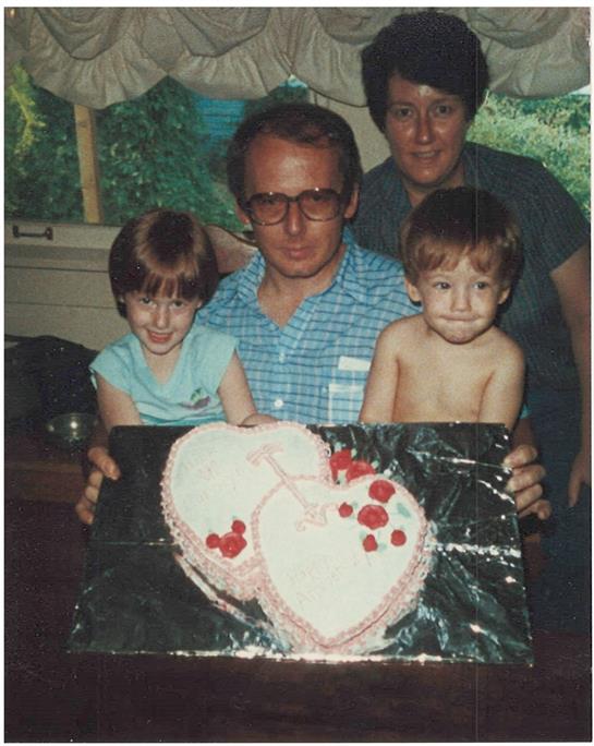 A man and woman holding a cake