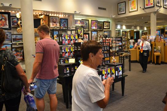 Guests stroll through the gallery, admiring various artworks and engaging with local artists.