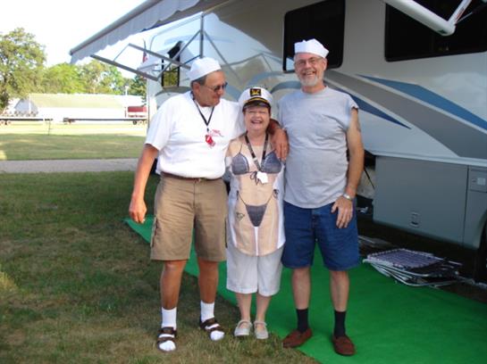 A group of people standing in front of a rv