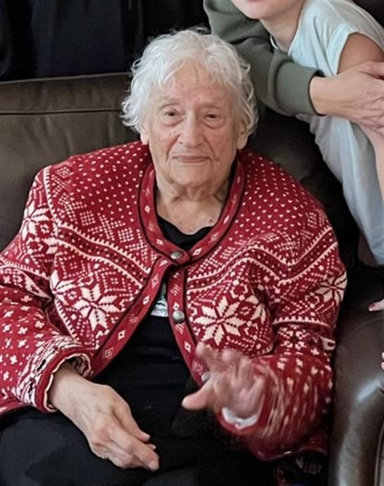 An old woman sitting on a couch