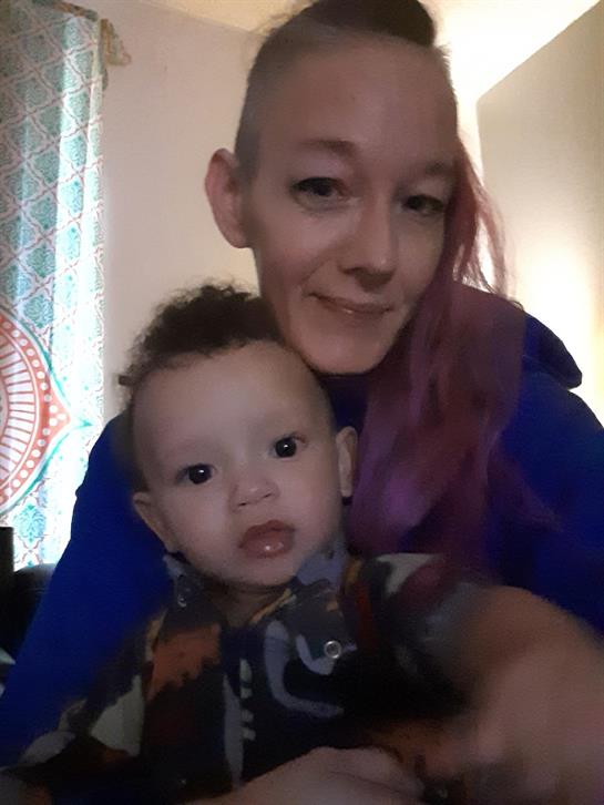 A mother sits with her young child in a warm, inviting room, sharing quality time together.