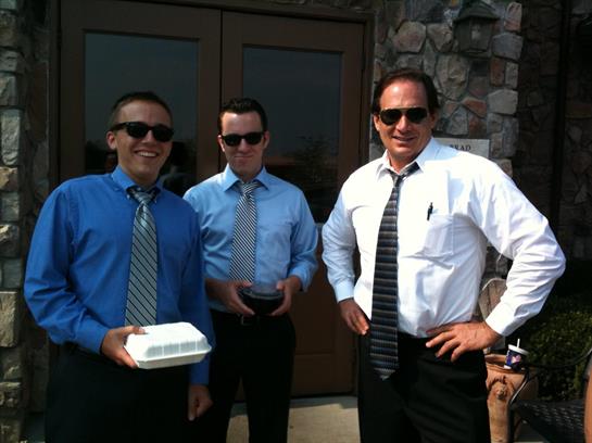 A group of men wearing ties and sunglasses