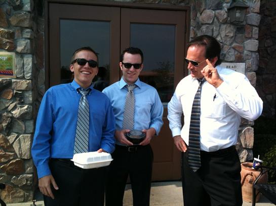 A group of men wearing ties and sunglasses