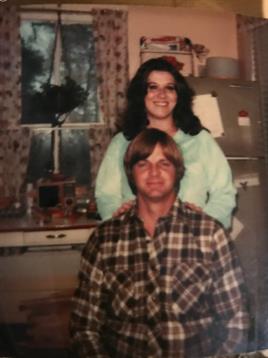 A woman standing on a man's shoulder