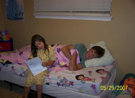 A man and a girl lying on a bed