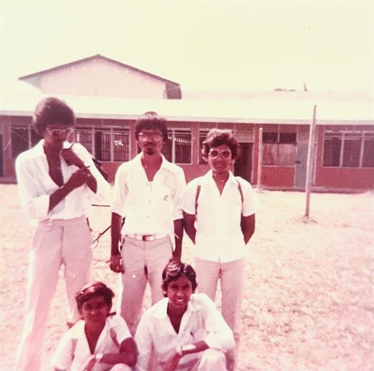 A group of men in white shirts and sunglasses