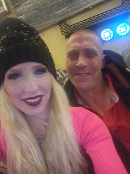 Two friends share a joyful selfie, dressed warmly and smiling in a relaxed atmosphere.