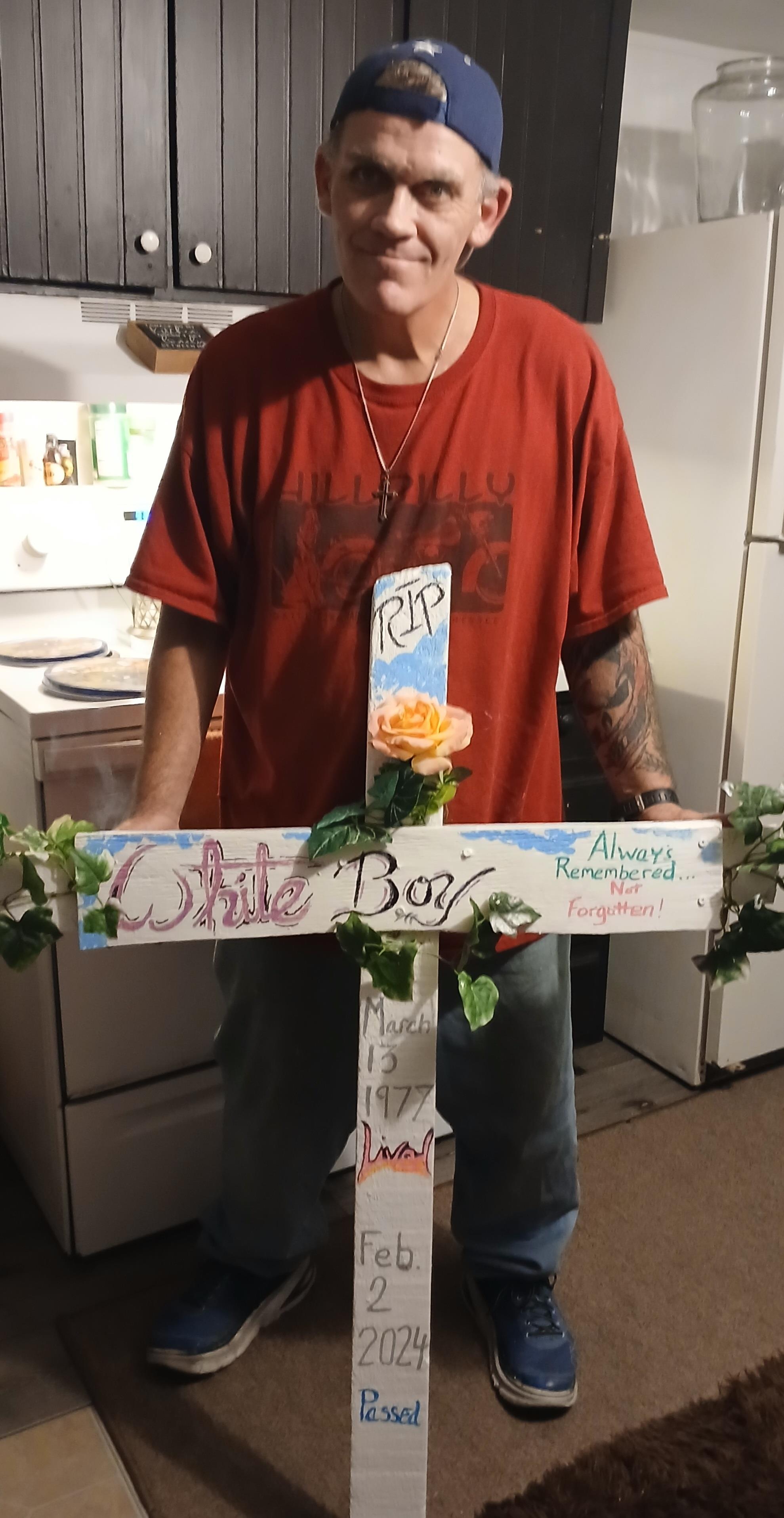 A heartfelt memorial set up in a kitchen, honoring a deceased individual with flowers and messages.