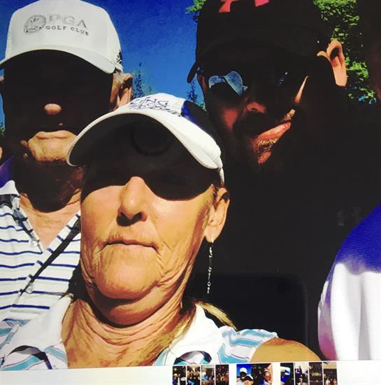 Three friends gather for a selfie while enjoying a sunny day at the golf course.