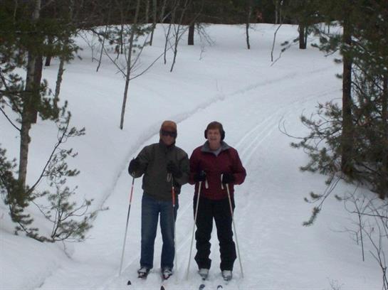 A couple of people skiing in the snow