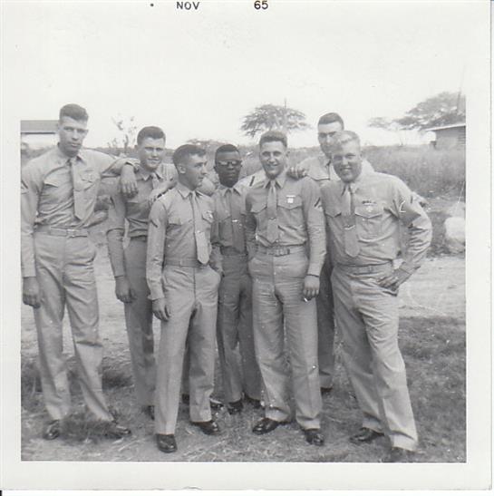 Soldiers are standing together in a casual pose, showcasing camaraderie in a historical context.