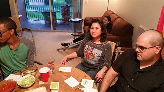 Four friends enjoy a fun evening with snacks and games in a comfortable living room.