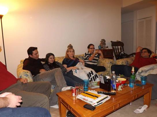 Group of friends enjoy a casual night together in a comfortable living room filled with warmth.